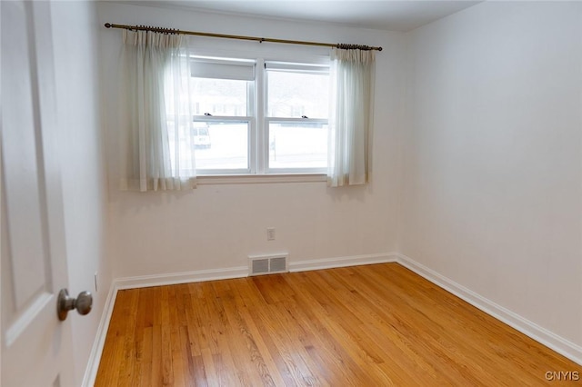 empty room with light hardwood / wood-style flooring