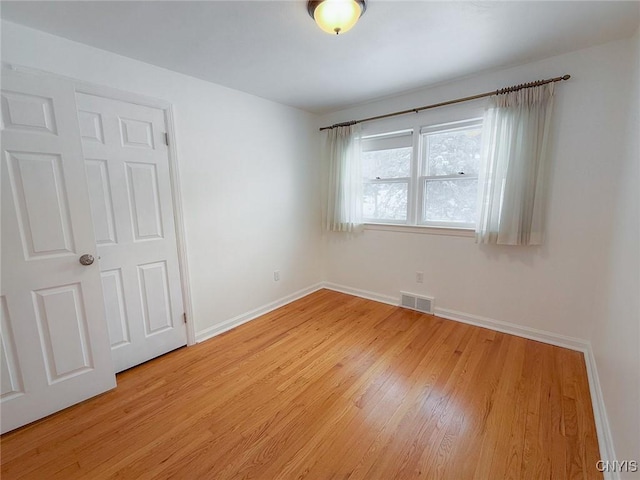 spare room with light hardwood / wood-style flooring