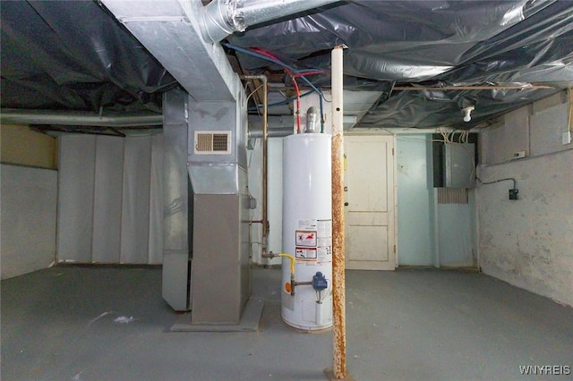 basement featuring electric panel and gas water heater