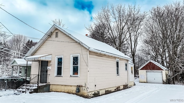 bungalow featuring an outbuilding and a garage