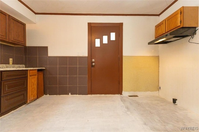 kitchen featuring tile walls and ornamental molding