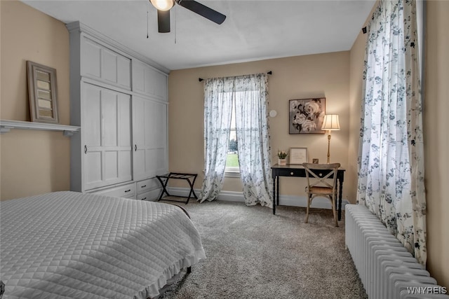 carpeted bedroom with radiator, ceiling fan, and a closet