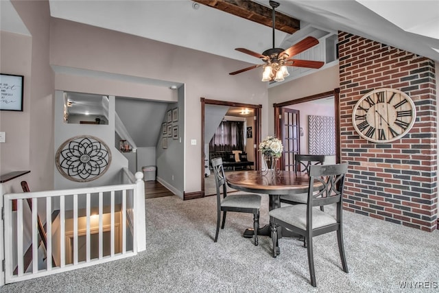 dining room featuring beam ceiling, high vaulted ceiling, and carpet flooring