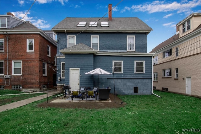 back of house featuring a patio area and a lawn