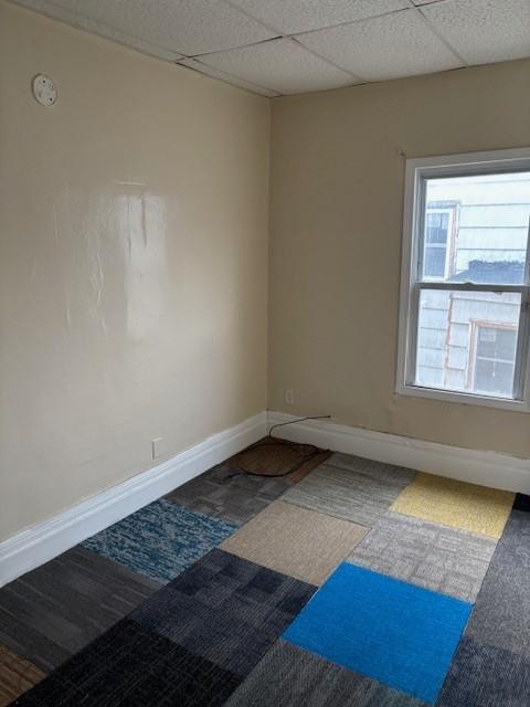 unfurnished room featuring a paneled ceiling