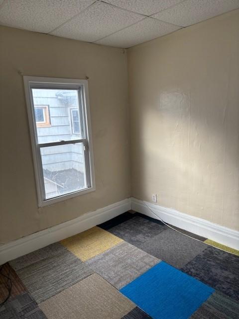 unfurnished room with a paneled ceiling