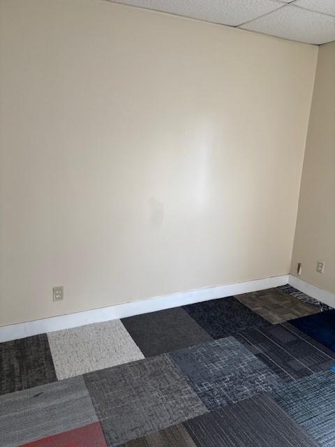 empty room featuring a paneled ceiling