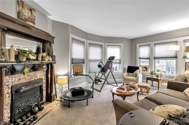 carpeted living room with a tile fireplace