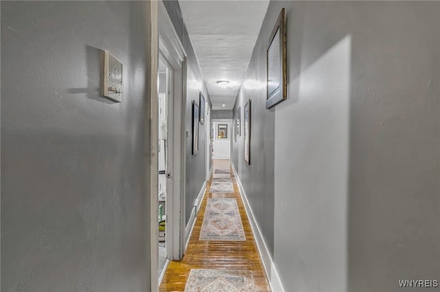 corridor with light hardwood / wood-style flooring