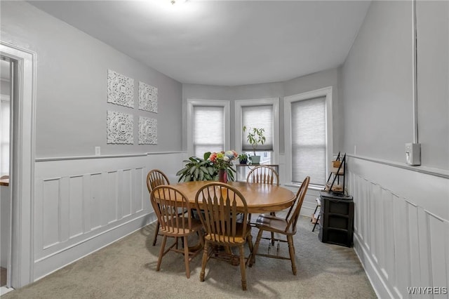 dining room featuring light carpet