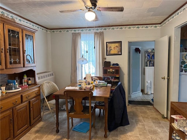 dining area with a wall unit AC and ceiling fan