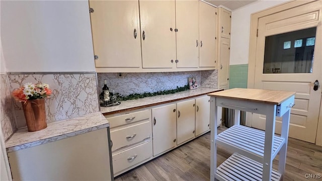 kitchen featuring tasteful backsplash, white cabinetry, and light hardwood / wood-style flooring