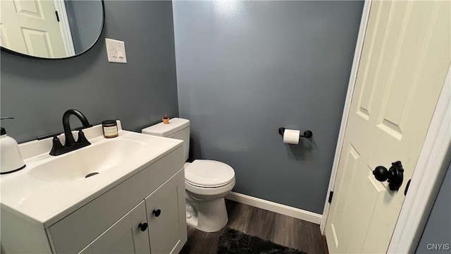 bathroom with vanity, wood-type flooring, and toilet