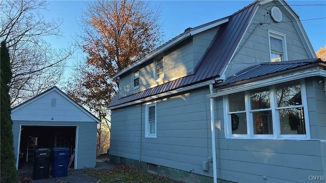 view of side of property featuring a garage and an outdoor structure