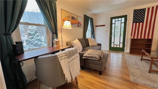 sitting room featuring light hardwood / wood-style flooring and ornamental molding