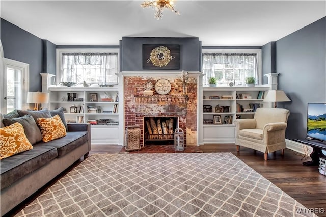 living room featuring dark wood-type flooring and a fireplace