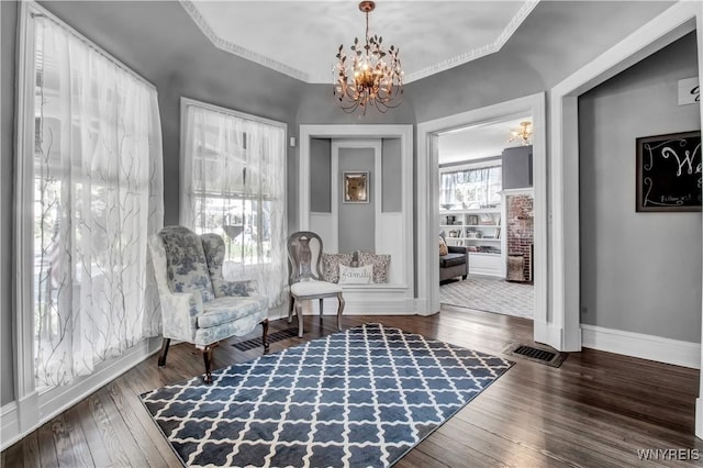 living area featuring an inviting chandelier and dark hardwood / wood-style flooring