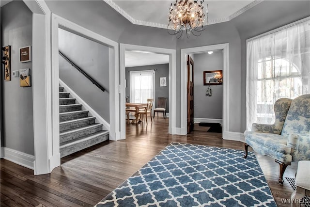 sitting room featuring dark wood-type flooring and a chandelier