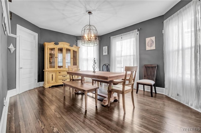 dining area featuring an inviting chandelier and dark hardwood / wood-style flooring