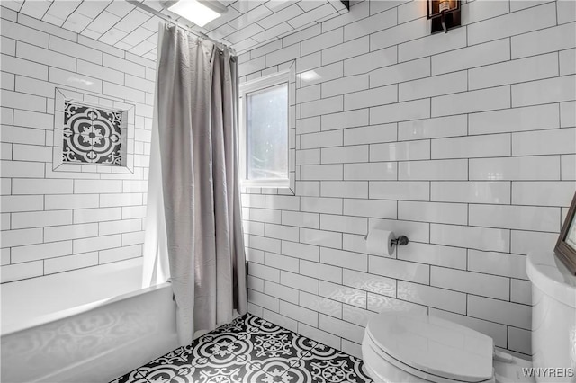 bathroom featuring shower / tub combo and toilet