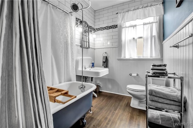 bathroom with hardwood / wood-style flooring and toilet