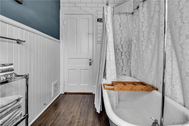 bathroom featuring hardwood / wood-style flooring and shower / bath combo