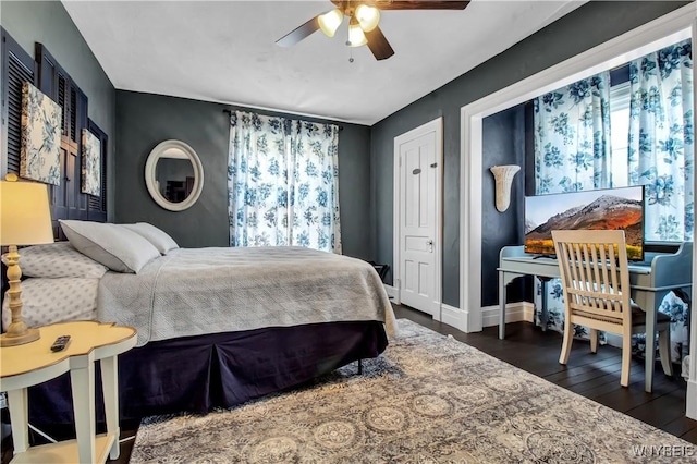 bedroom with dark wood-type flooring and ceiling fan