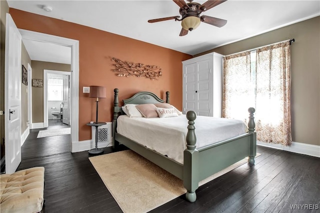 bedroom with dark hardwood / wood-style floors and ceiling fan