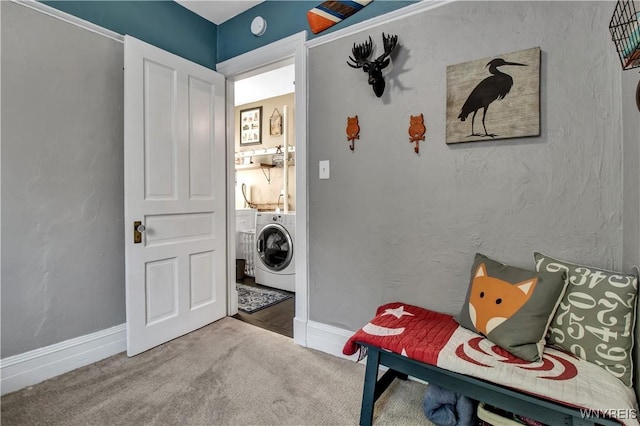 laundry area featuring washing machine and dryer and carpet