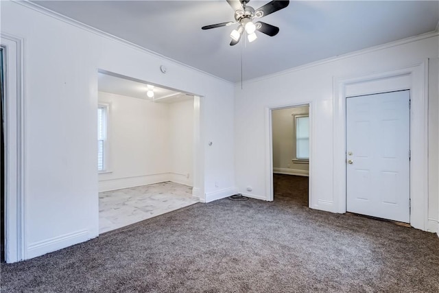 carpeted empty room with ornamental molding and ceiling fan