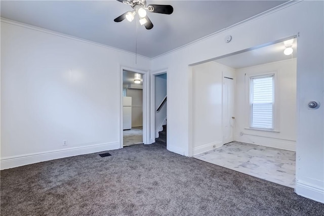 carpeted empty room featuring ornamental molding and ceiling fan