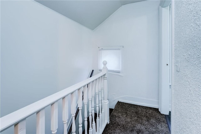 stairs with lofted ceiling and carpet