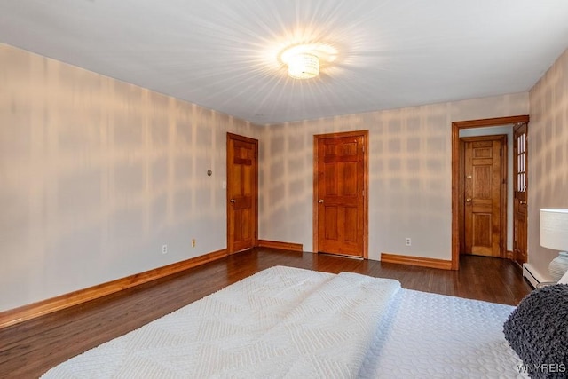 bedroom with dark wood-type flooring