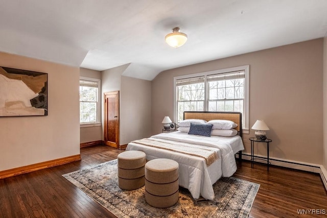 bedroom featuring baseboard heating, lofted ceiling, and dark hardwood / wood-style floors