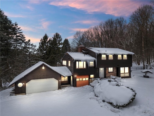 view of front of house with a garage and a chimney