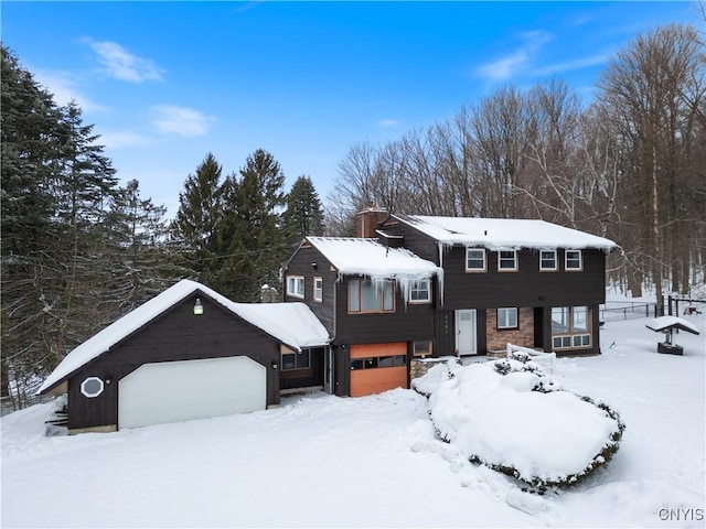 view of front of property with a garage and a chimney