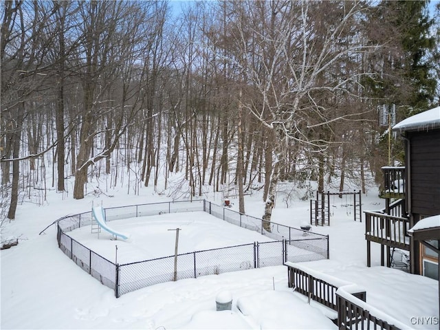 yard covered in snow with stairway and fence