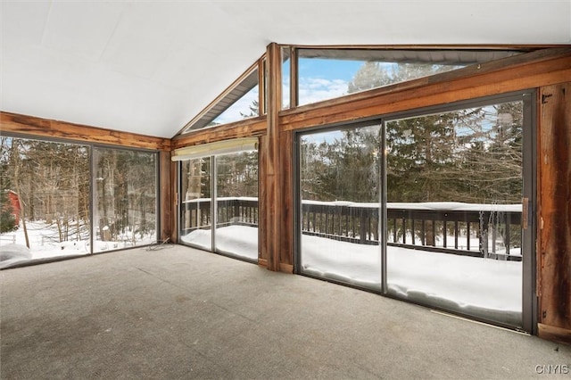 unfurnished sunroom with vaulted ceiling and a healthy amount of sunlight