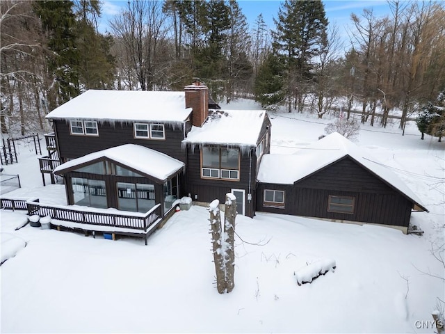 view of front of property with a deck and a chimney