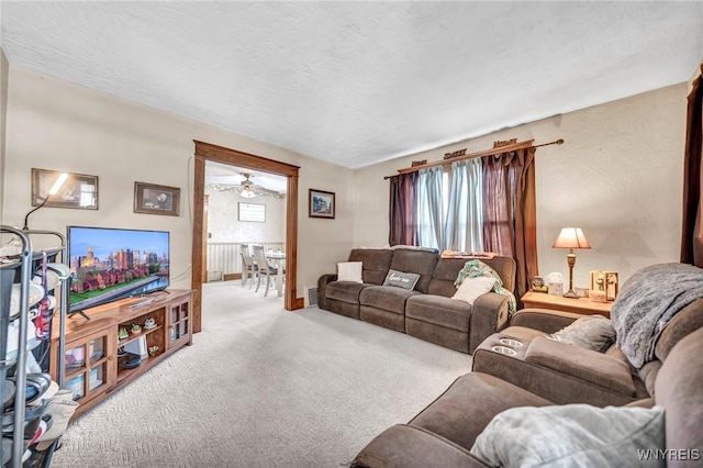 carpeted living room featuring a textured ceiling