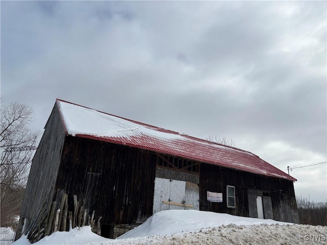 view of snowy exterior with an outdoor structure