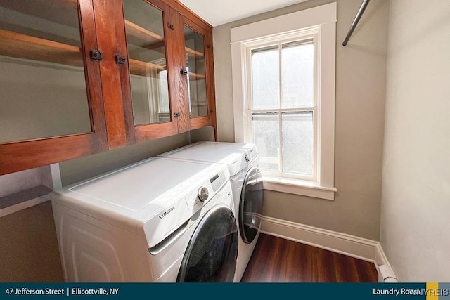 washroom with cabinet space, dark wood-style floors, baseboards, and washing machine and clothes dryer