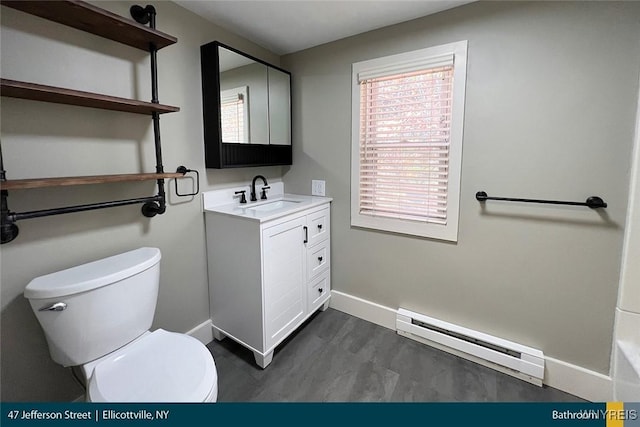 bathroom featuring a baseboard radiator, hardwood / wood-style floors, vanity, and toilet