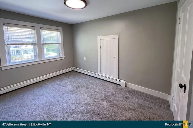 empty room with carpet, a baseboard radiator, and baseboards