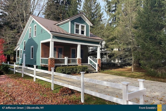 view of front of home featuring covered porch and metal roof