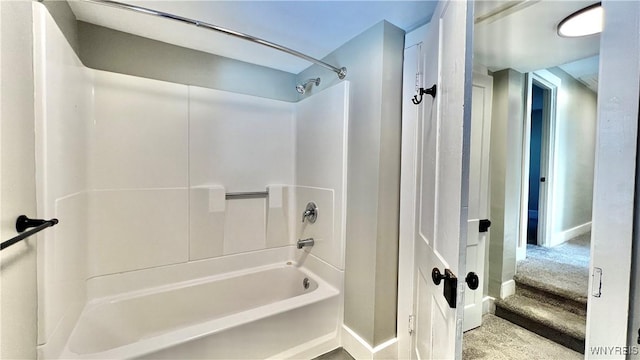 full bath featuring baseboards and shower / tub combination