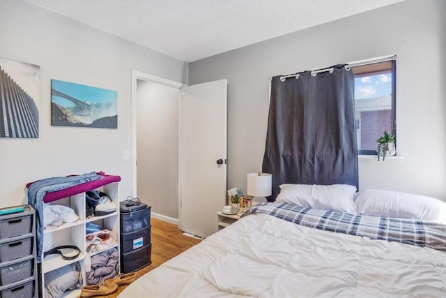 bedroom with hardwood / wood-style flooring and a textured ceiling