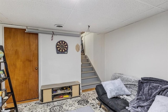 living area with a drop ceiling