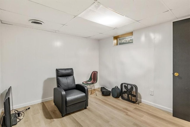 sitting room featuring hardwood / wood-style flooring and a paneled ceiling