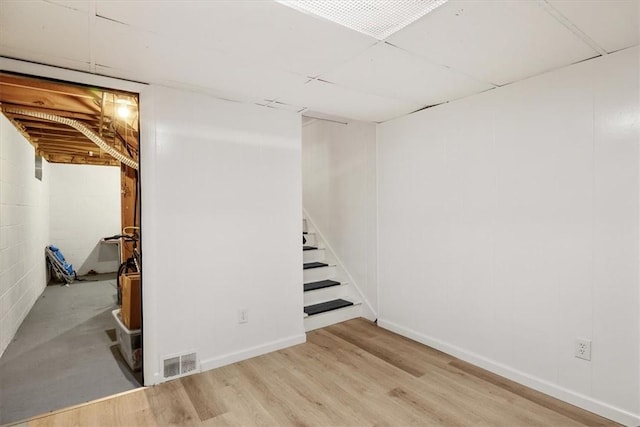 basement with light hardwood / wood-style floors